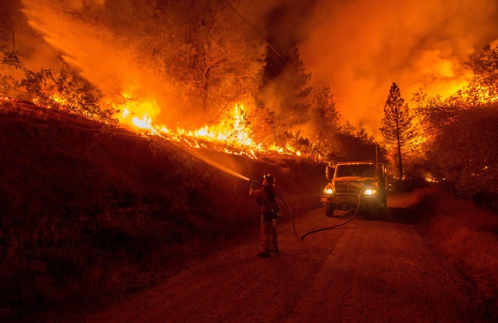 A firefighter douses flames from a backfire while battling the Butte fire near San Andreas, California, on Sept. 12. Wildfires have spread rapidly through northern California, destroying hundreds of homes, forcing thousands of people to flee and injuring four firefighters.