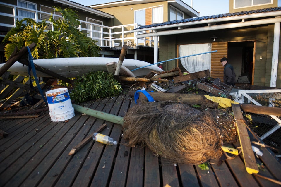 Fallen trees and other debris wash in front of houses in Concon, Chile, on Sept. 17,