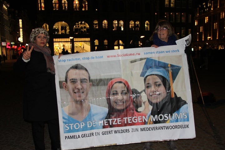 People attend a vigil in Amsterdam on Feb. 13, 2015, for three Muslim students who were shot dead in Chapel Hill, North Carolina.