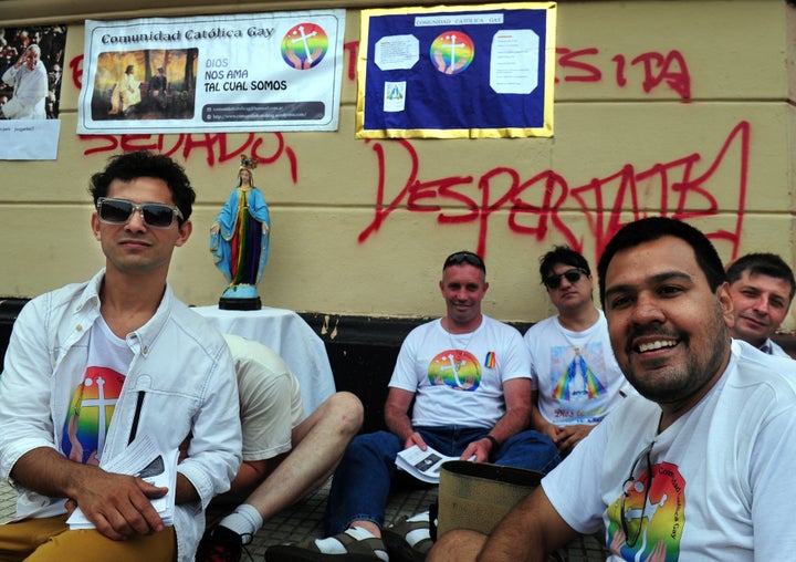 A group of Catholics pose with images of Pope Francis and the Virgin Mary in Plaza de Mayo, in Buenos Aires, during a gay pride parade on Nov. 9, 2013.