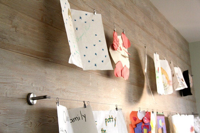 Curtain wire and clips are perfect for displaying kids' art because you can interchange the artwork!Get the instructions here