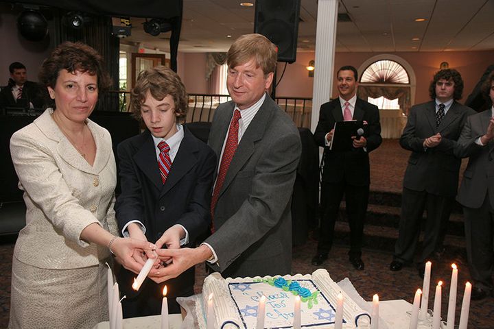Ari McVeigh, center, lights candles with his Jewish mother, Rebecca Bernstein McVeigh, and his non-Jewish father, Rod McVeigh, at his bar mitzvah.