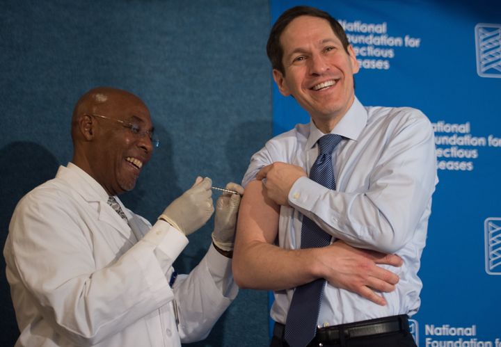 Tom Frieden (R), Director of the Centers for Disease Control and Prevention (CDC) receives a flu vaccine during the Influenza Outlook 2015-2016: Preparing for the Upcoming Season press conference at the National Press Club in Washington, DC, on September 17, 2015. AFP PHOTO/NICHOLAS KAMM 