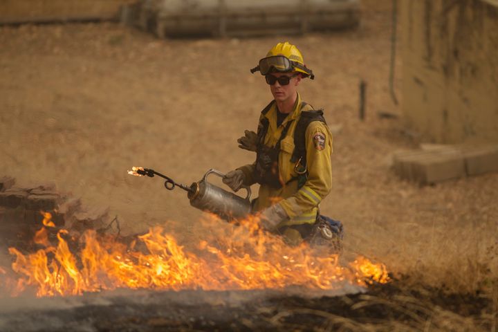 A firefighter sets a backfire near San Andreas, California.