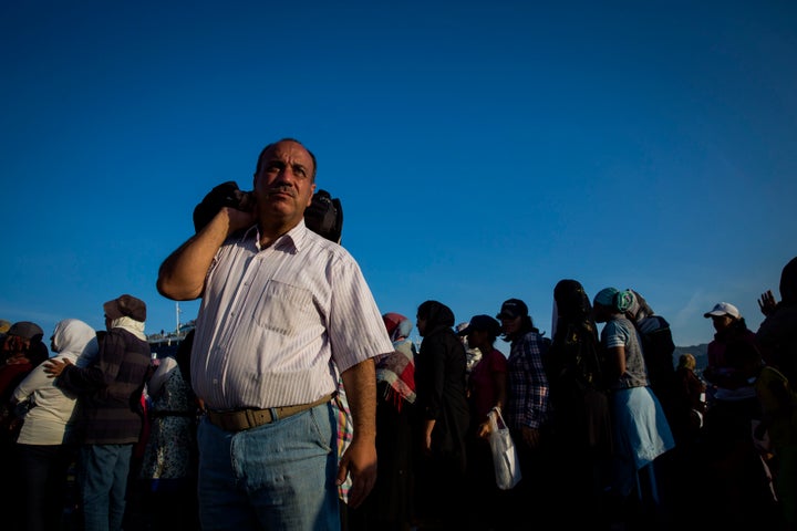 Refugees line up for ferry tickets at the port in Mytilini in Lesbos, Greece.