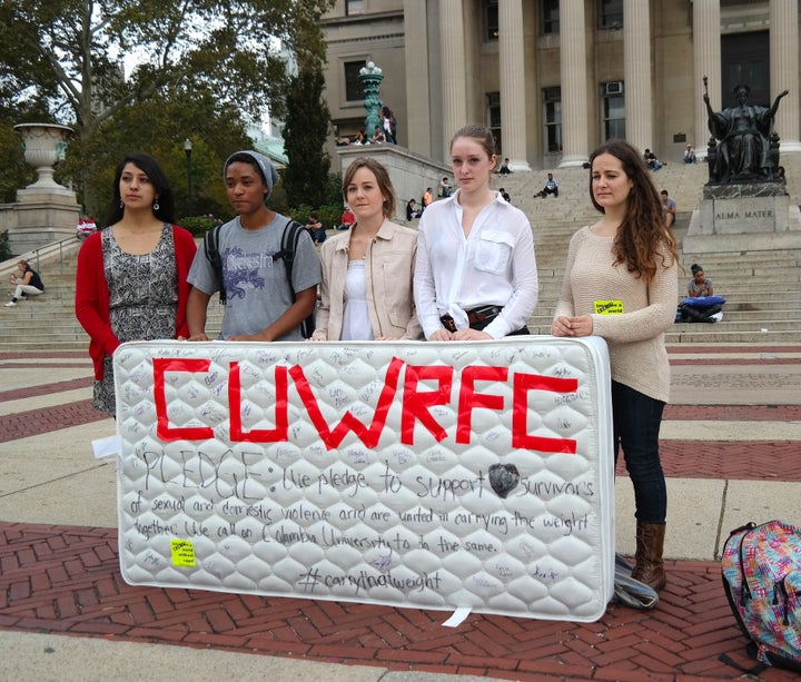 Students stand in front of the Library of the Columbia University with a mattress in protest of the university's handling of sexual assault.
