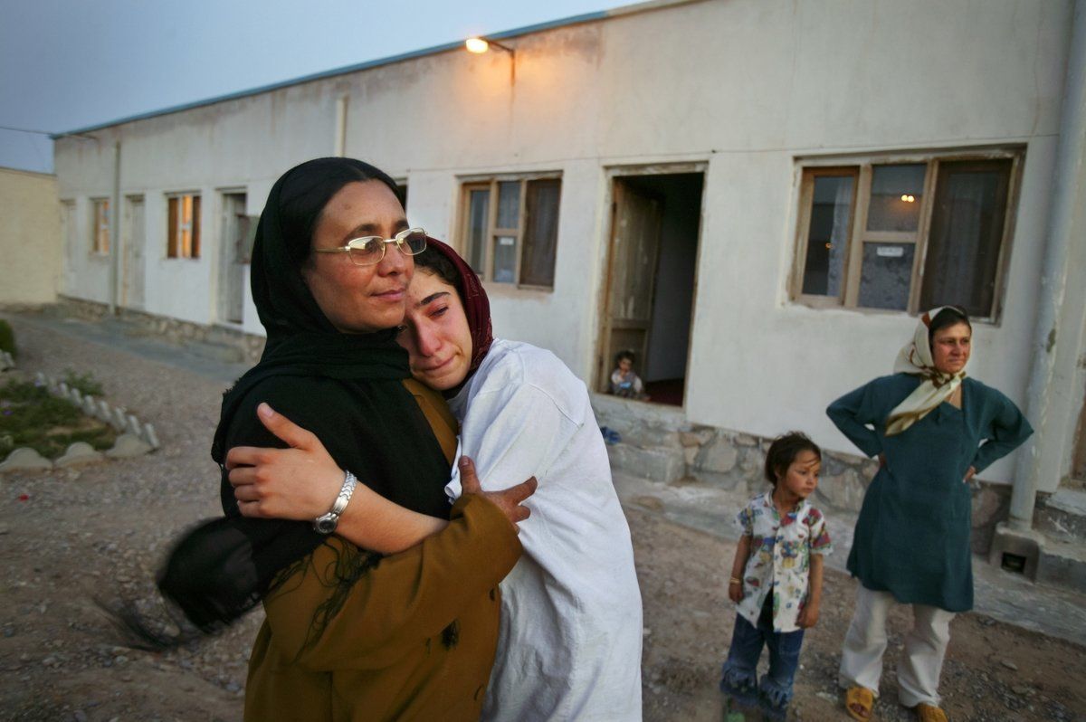 Mejgon, 16, weeps in the arms of her caseworker near fellow residents at an NGO shelter run by Afghan women in Herat, Afghanistan. Mejgon’s father sold her at the age of 11 to a 60-year-old man for two boxes of heroin.