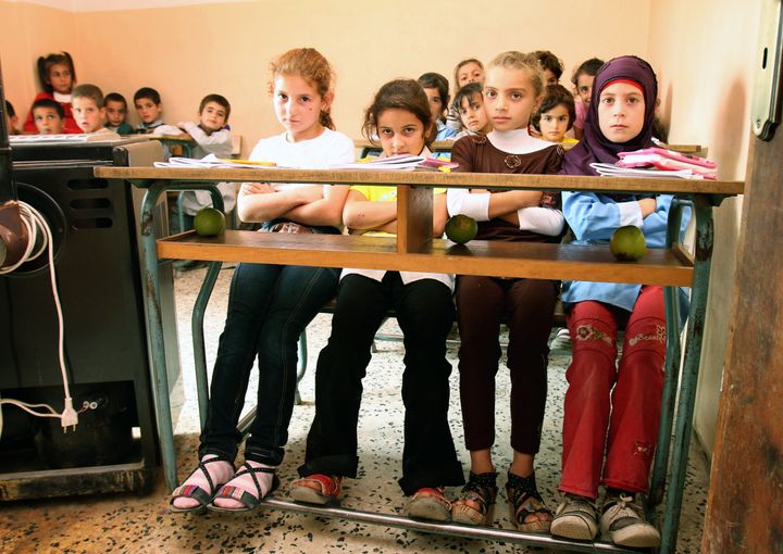 Lebanese children sit at their desk in their class room in the tiny village of Deir Dalloum, in northern Lebanon.
