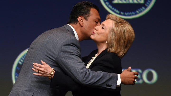 California Secretary of State Alex Padilla (L) greets Democratic presidential candidate and former U.S. Secretary of State Hillary Clinton. Both support automatic registration.