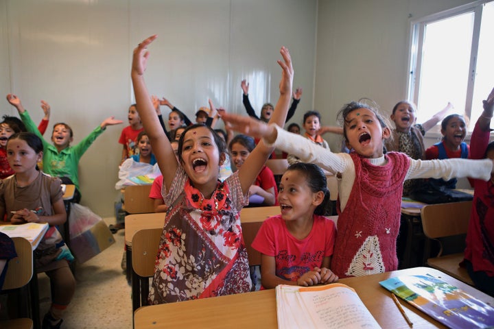 Syrian refugee students welcome as German Economy Minister Sigmar Gabriel visits the classroom during his visit at the Zaatar