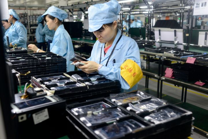 Workers produce electronic products in Dongguan, Guangdong province of China. Chinese manufacturing has been performing poorly of late.