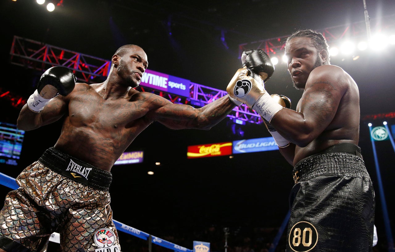 Deontay Wilder hits Bermane Stiverne during their WBC heavyweight title bout on Jan. 17 in Las Vegas.