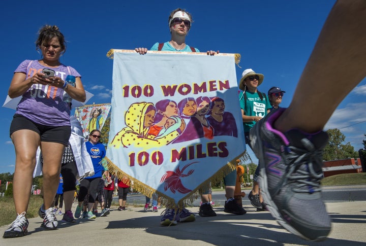 Participants in the "100 Women 100 Miles Pilgrimage" walk on a road after a lunch break on their trek, after stopping at the University Maryland Baltimore County in Baltimore on Sept. 20, 2015.