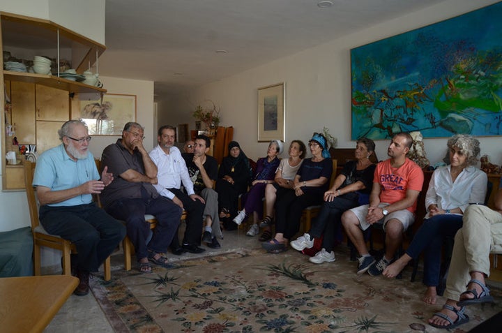 An interfaith group gathered in a private home on Sept. 21, 2015, to defuse potential tensions over how Jews and Muslims celebrate Yom Kippur and Eid al-Adha, two holidays that overlap this year. Two dozen people of various faiths heard a rabbi explain the laws and traditions of Yom Kippur, the Jewish Day of Atonement, and a Muslim sheikh explain the laws and traditions of Eid al-Adha, the Muslim holiday that honors the willingness of Ibrahim (the biblical Abraham) to heed God’s order to sacrifice his son.