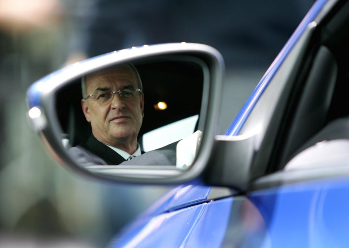Martin Winterkorn looks in the rearview mirror as he sits in the Volkswagen model 'Scirocco' during the company's annual