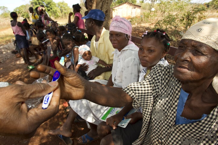 Families receive toothpaste and toothbrushes as they wait in line at a clinic staffed by visiting volunteers on Isle de la Gonave, Haiti. Since the 2010 earthquake Port-au-Prince residents have fled to the island increasing it's population by 30 percent. (Photo by Alyce Henson/Rotary International/Getty Images)