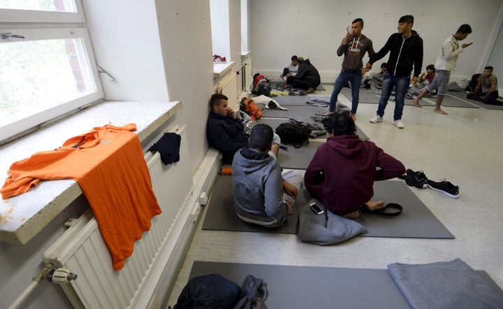Iraqis rest in a refugee center in Lahti, Finland, on Sept. 25, 2015, after demonstrator attack their bus with stones and fir