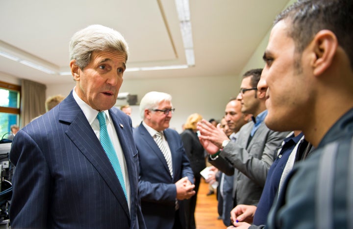 German Foreign Minister Frank-Walter Steinmeier and Secretary of State John Kerry meet with refugees from Syria on September 20, 2015 in Berlin, Germany.