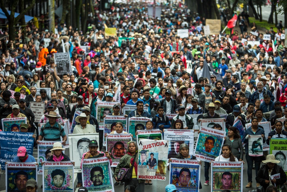 Relatives of the 43 missing students of Ayotzinapa march during the one-year anniversary of their disappearance in Mexico&nbs