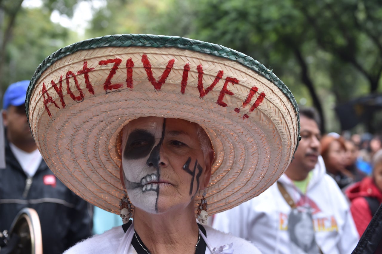 A woman takes part in a protest in Mexico City on Sept. 26, 2015, to commemorate the first anniversary of Ayotzinapa students' disappearance. Many held images of the students and banners calling for their safe return.