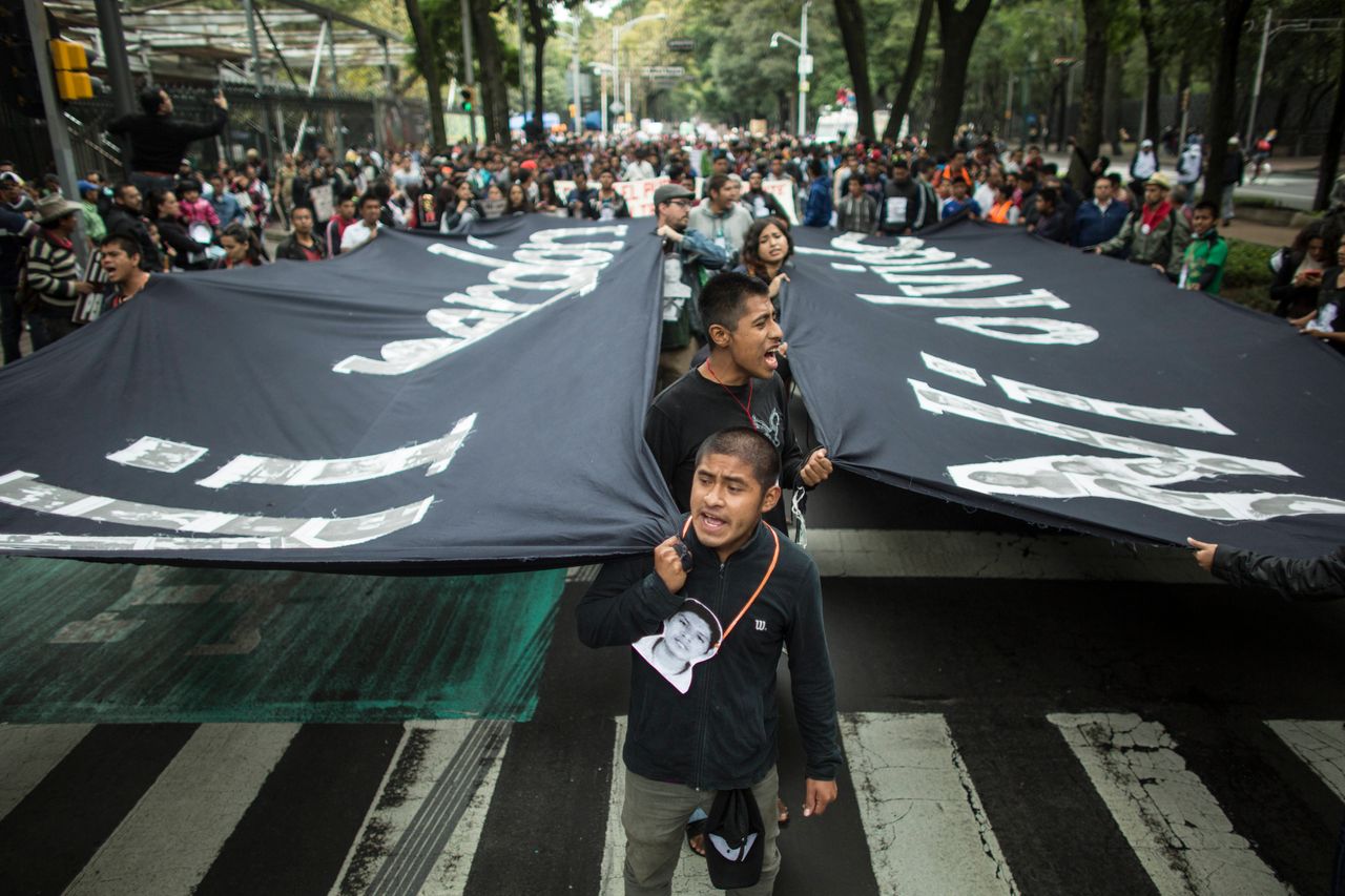 Classmates of the missing Ayotzinapa students shout slogans during the one-year anniversary of the disappearance march on September 26, 2015 in Mexico City.