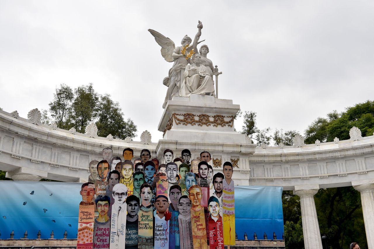 Banners of 43 missing students are displayed during a march in Mexico City to commemorate the anniversary of their disappearance.