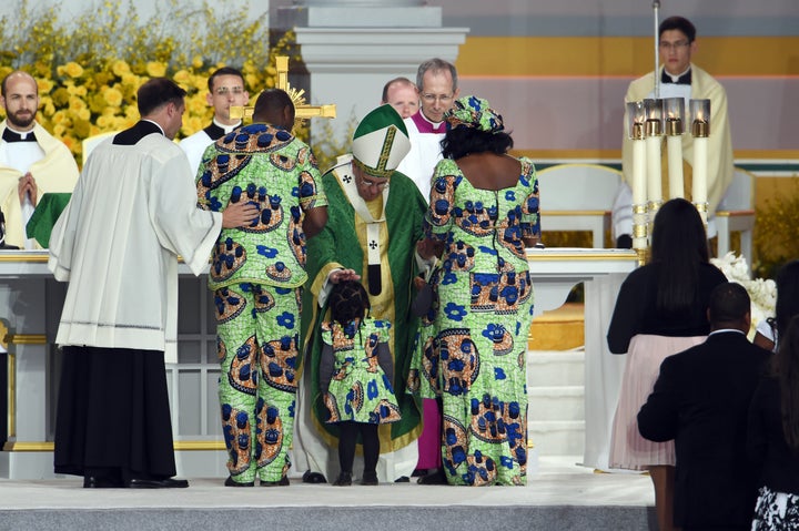Pope Francis blesses a family during an open-air mass at the Benjamin Franklin Parkway in Philadelphia, Pennsylvania, on Sept