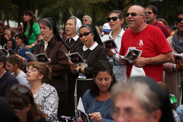 Members of the congregation sing during the Mass for the conclusion of the World Meeting of Families on Benjamin Franklin Parkway September 27, 2015 in Philadelphia, Pennsylvania. 