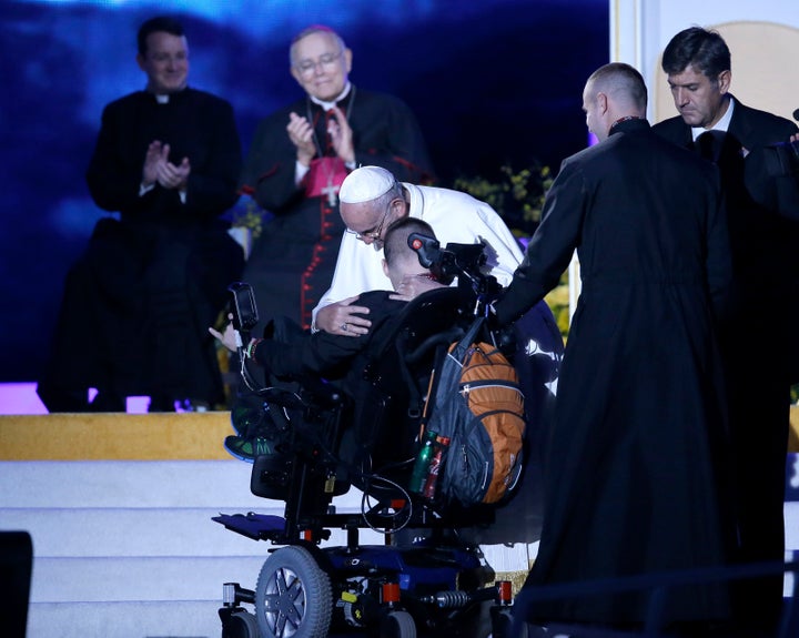 Pope Francis hugs a disabled member of a Ukrainian family during the Festival of Families on September 26, 2015 in Philadelphia, Pennsylvania.