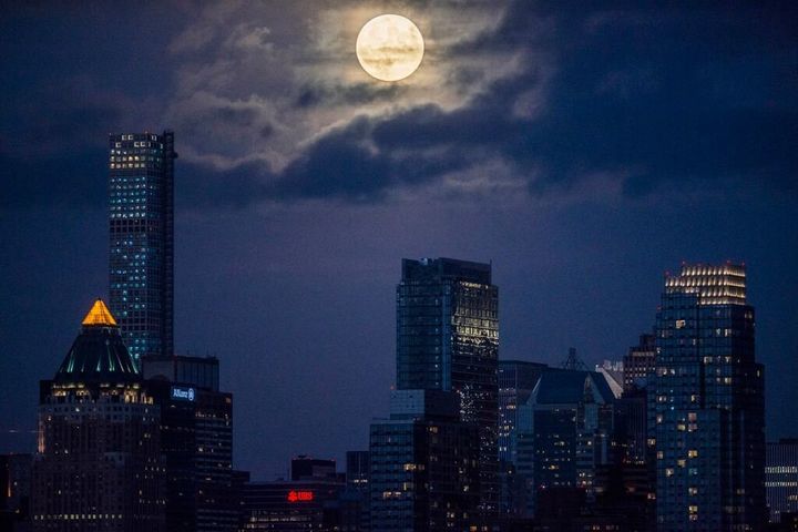 After some waiting and worrying we wouldn't see the supermoon because of the dense cloud cover my son and I saw it break through the heavy gray backdrop over NYC. Images were taken from the cliff on Lincoln Place street in Weehawken NJ.