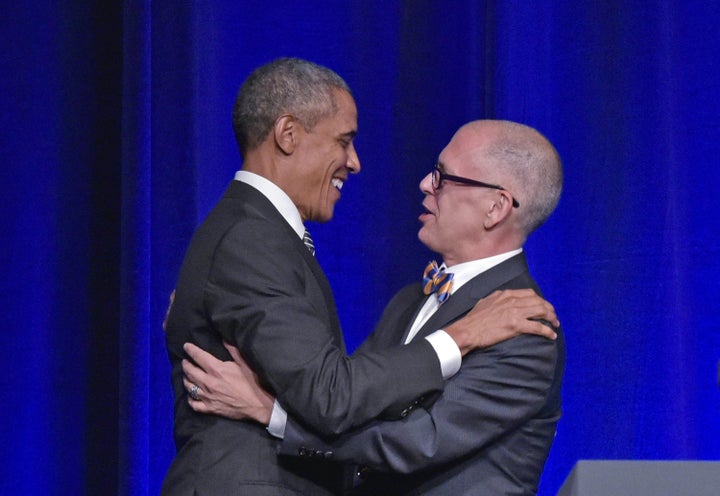 US President Barack Obama (L) hugs Jim Obergefell, who introduced him, as he arrives on stage to speak at the Democratic National Committee LGBT Gala at Gotham Hall in New York, New York on September 27, 2015. AFP PHOTO/MANDEL NGAN