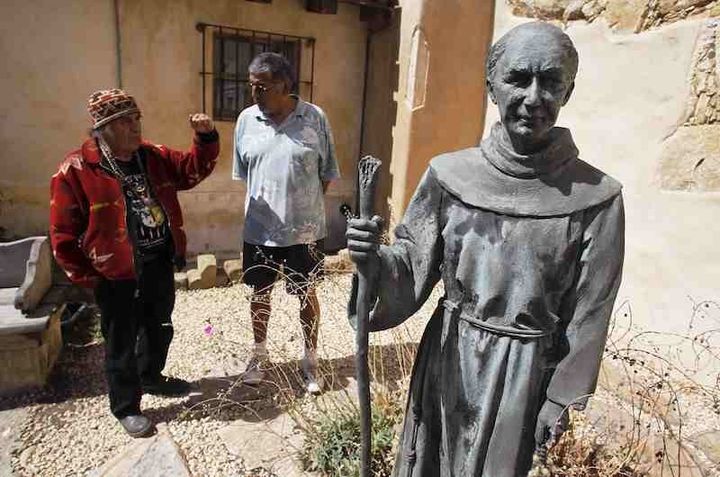 Chief Tony Cerda (L) of the Costanoan Rumsen Carmel Tribe of the Ohlone Nation and Rudy Rosales, Tribal Chairperson of the Ohlone Costanoan Esselen Natio, stand next to a statue of Franciscan Friar Junipero Serra at the Carmel Mission in Carmel, California.