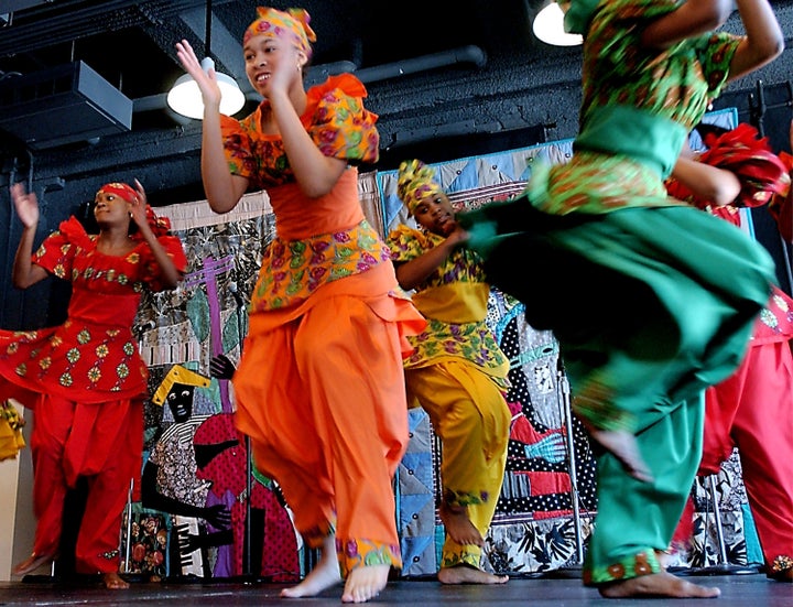 Members of the Restoration Dance Company perform a traditional African dance during a Kwanzaa festival at the Museum of Natural History December 28, 2002 in New York City. Kwanzaa, started in 1966 by Dr. Maulana Karenga, is an African-American cultural holiday celebrating family and community.