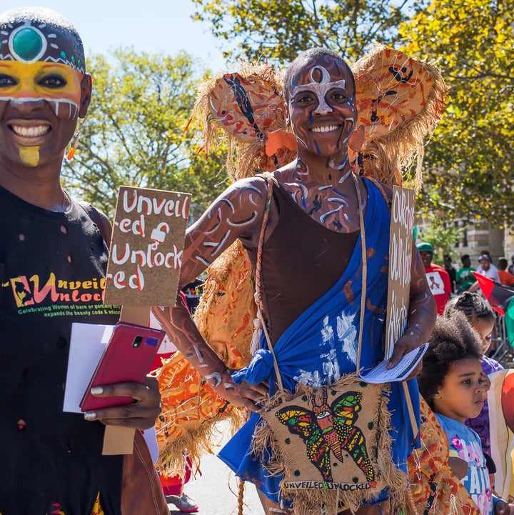 Parade participants march with a tribal themed group wearing colorful face paint. The 46th Annual African-American Day Parade was held in Harlem; the spectators, politicians and prominent members of Harlem's black community celebrated the historically-rich NYC community of those from different African heritages.