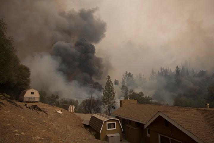 Smoke rises near a house on Mountain Ranch Road at the Butte Fire near San Andreas, California, on Sept. 13, 2015.