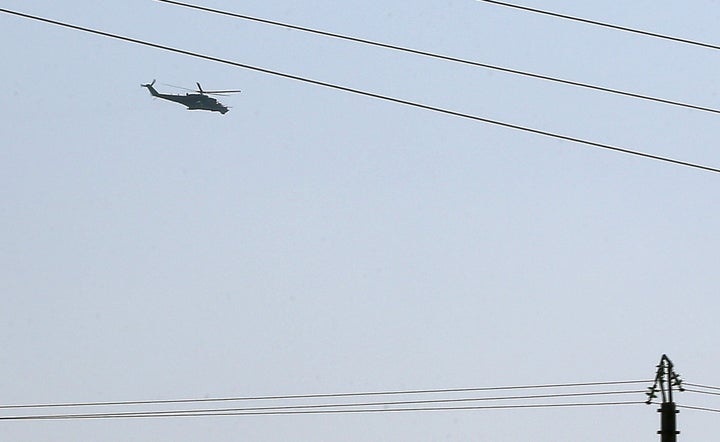 A Russian Mi-35 attack helicopter hovers over Latakia airport in Syria on Sept. 24, 2015. Russia had already sent military experts to a command center in Baghdad, Iraq, that is coordinating air strikes and ground troops in Syria, a Russian officials said.