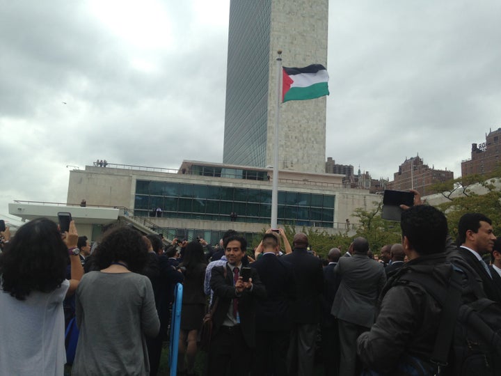 A man takes a selfie in front of the Palestinian flag after it was raised at the U.N. headquarters for the first time on Sept. 30, 2015.