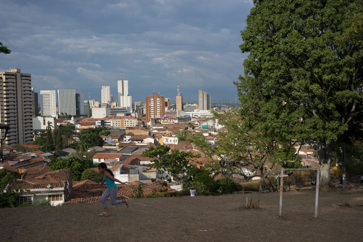 A young girl runs in the San Antonio Church Park in Cali, Colombia, on Wednesday, Aug. 12, 2015.