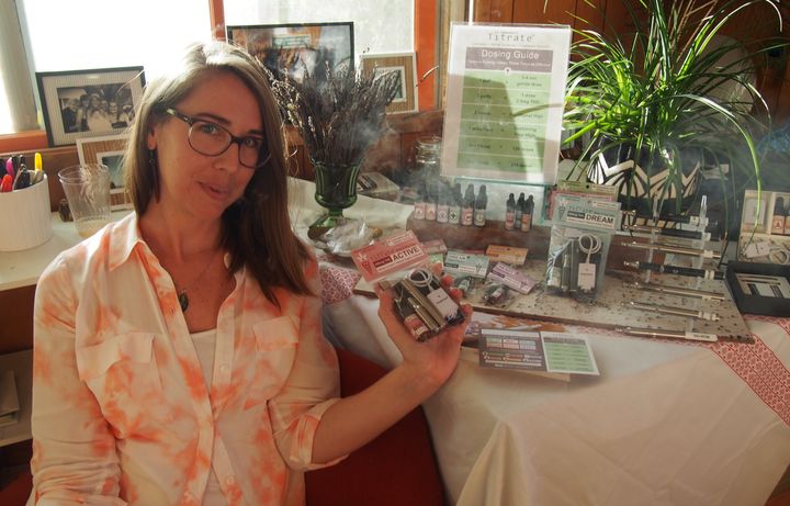 Dyana Patamia of Titrate shows off her company's selection of herbal and THC-infused e-juices at a house party in Portland, celebrating the end of prohibition on Oct. 1, 2015.