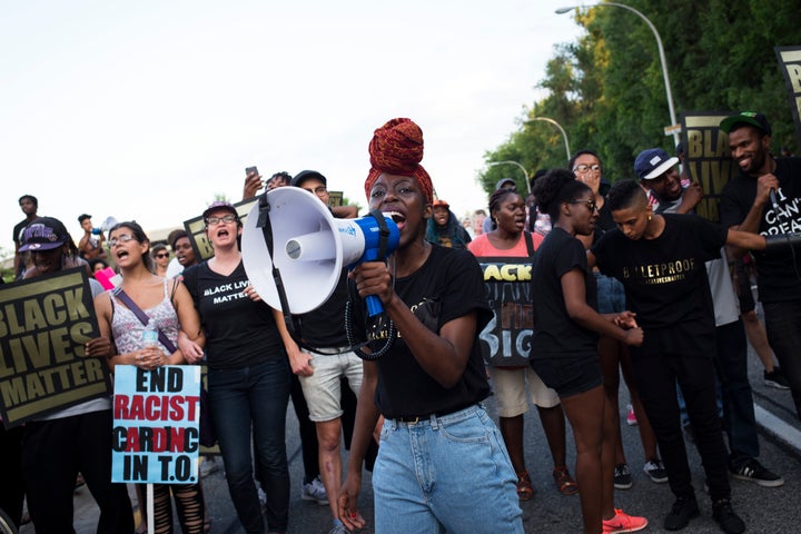 Tari Ngangura screams into a microphone during a Black Lives Matter protest