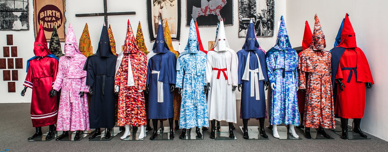 <strong>Birth of a Nation Project</strong><strong>:</strong> a recast of KKK robes in Kente, camouflage, white satin, and other fabrics. For the year 2015, Rucker is creating at least one new Ku Klux Klan robe a week. 