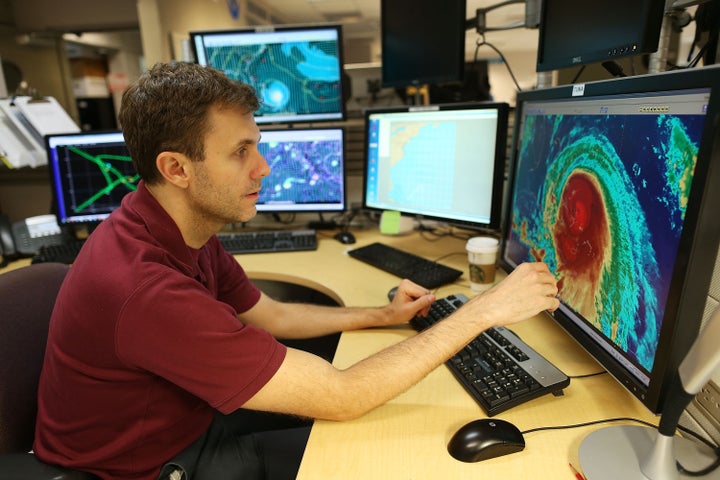 Eric Blake, a hurricane specialist, uses a computer at the National Hurricane Center to track the path of Hurricane Joaquin as it passes over parts of the Bahamas.