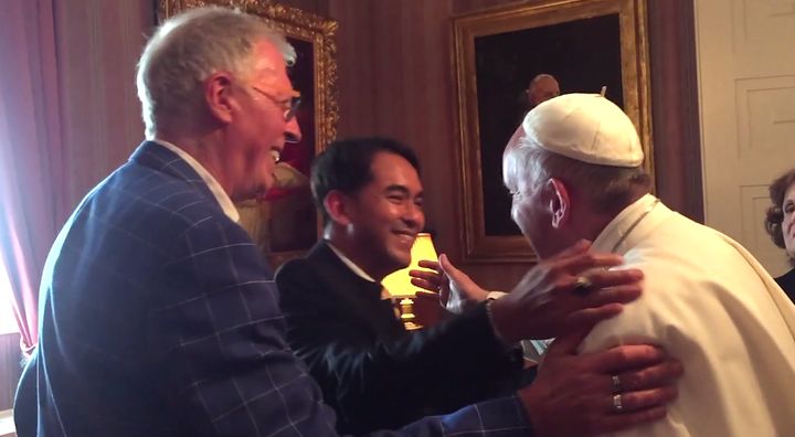 In this still from a video taken by Marisa Marchitelli, Yayo Grassi, left, and his partner Iwan Bagus, center, can be seen greeting Pope Francis, right, at the Apostolic Nunciature in Washington, D.C.