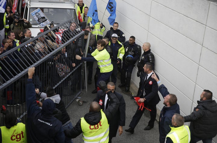 Demonstrators try to enter to Air France headquarters in Roissy-en-France, on Oct. 5, 2015, during a demonstration for the launch of a restructuring plan at a central committee meeting.