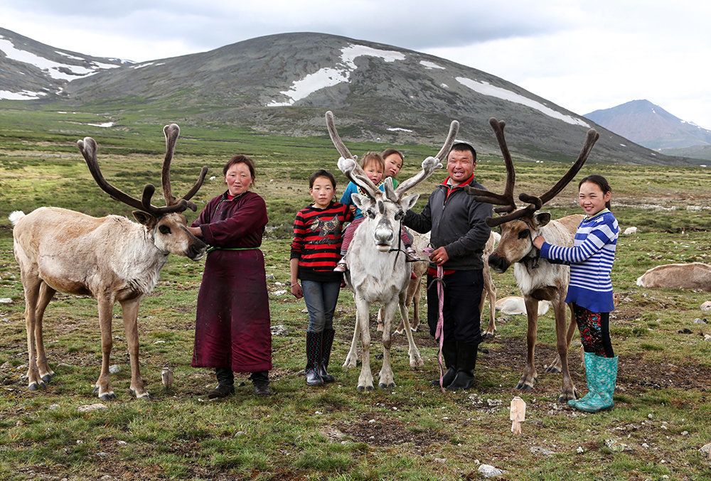 The entire family poses proudly with some of their reindeers. From left to right, Bolorma, Ulziitsetseg, Tuvshinbayar, Ulziichimig, Narahuu and the oldest daughter Ulziisaihan.