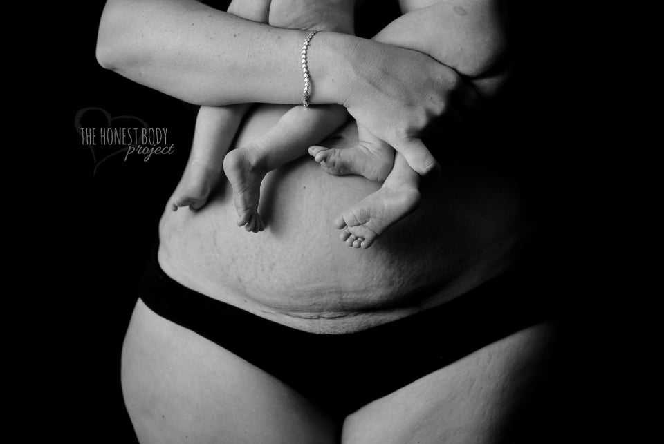 Monochrome Shot of Woman in Underwear Holding Stomach in Pain