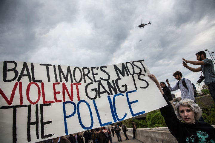 Several Baltimore police officers conspired to send vehicles from accident scenes to a local auto repair shop. All but one pleaded guilty to multiple federal extortion charges. Above, protesters march in support of Maryland's announcement that Baltimore police officers would be charged in the May 2015 death of Freddie Gray.