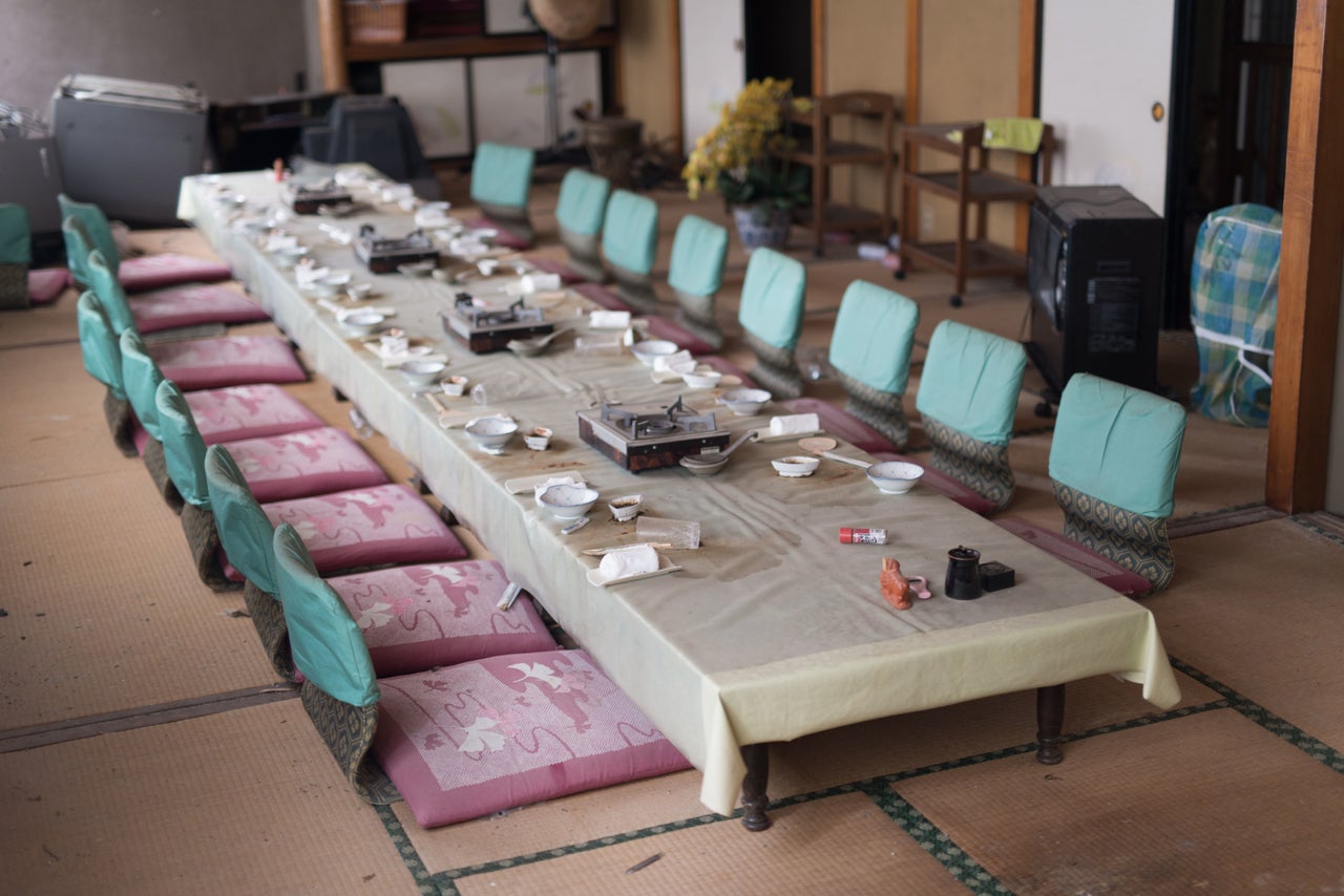 A restaurant table with crockery left behind by guests.