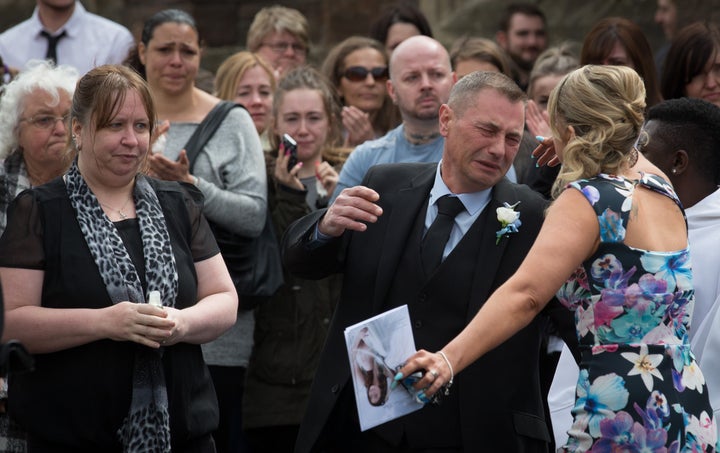 APRIL 17: Darren Galsworthy (C) is comforted after he released a dove following the memorial service at St Ambrose Church for