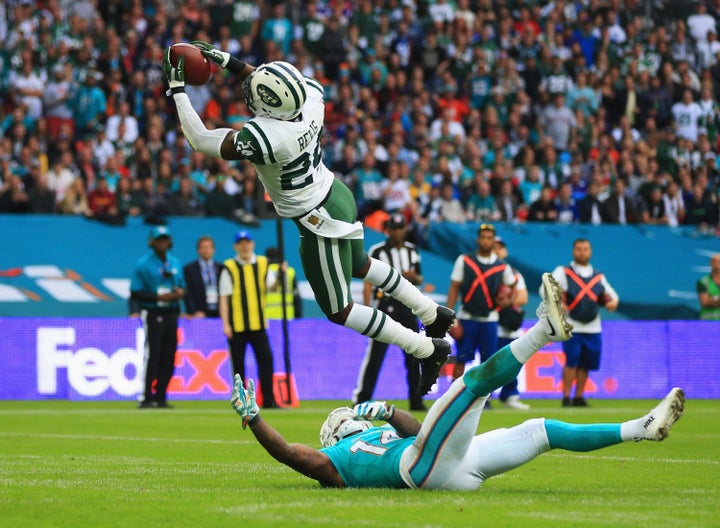 Darrelle Revis of the New York Jets intercepts a pass intended for Jarvis Landry of the Miami Dolphins on Oct. 4, 2015.